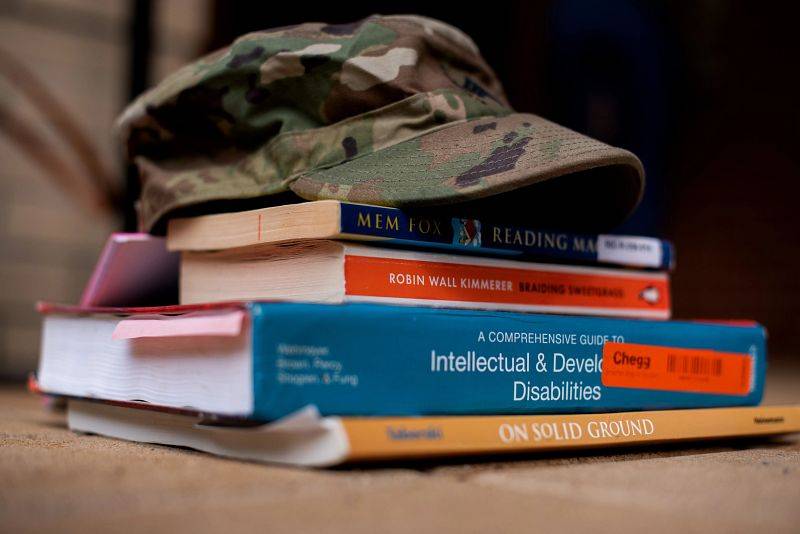 A military hat on textbooks.